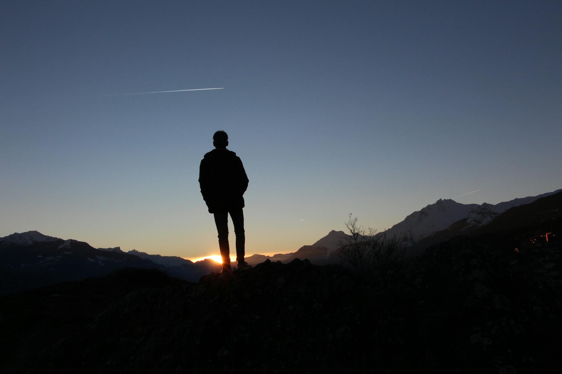 silhouette of a man standing during sunset